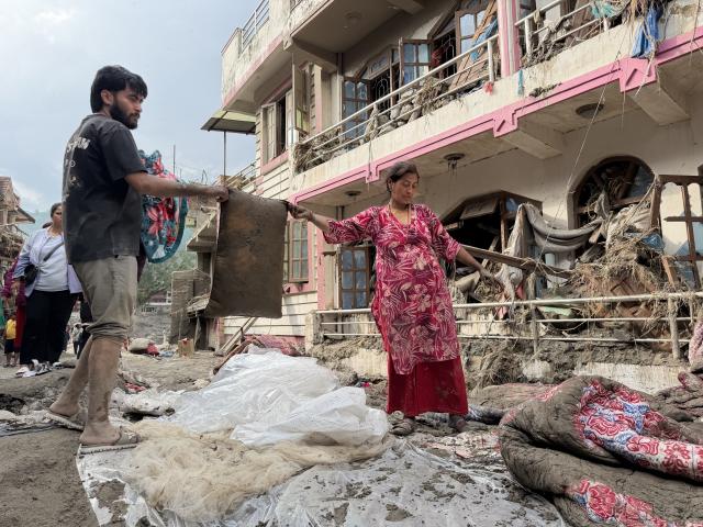 (260830) -- NUWAKOT, Aug. 30, 2026 (Xinhua) -- This photo taken with a mobile phone shows mudslide-affected residents cleaning up their belongings in Devighat in Nuwakot, Nepal, Aug. 29, 2026. As of 9 a.m. local time on Sunday, 734 bodies had been recovered from mudslide-hit areas, with 2,498 people still missing, according to Nepal's National Disaster Risk Reduction and Management Authority. (Xinhua/Zhao Manjun)