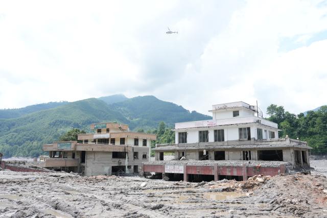 (260830) -- NUWAKOT, Aug. 30, 2026 (Xinhua) -- A helicopter flies over the mudslide-affected area along the Trishuli River in Nuwakot, Nepal, Aug. 29, 2026. As of 9 a.m. local time on Sunday, 734 bodies had been recovered from mudslide-hit areas, with 2,498 people still missing, according to Nepal's National Disaster Risk Reduction and Management Authority. (Xinhua/Liu Tian)