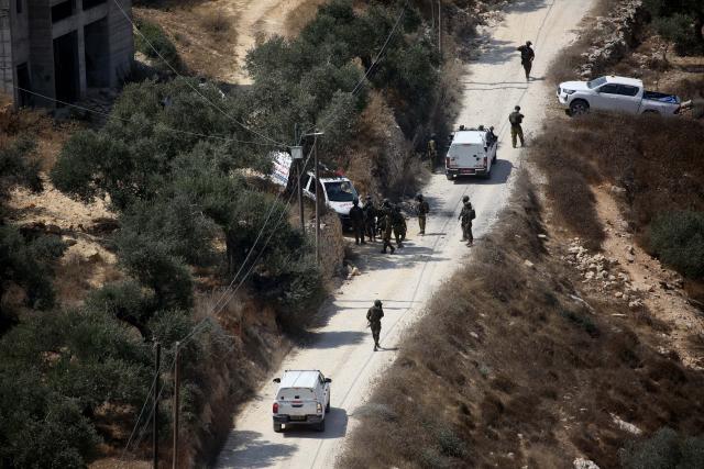 (260830) -- NABLUS, Aug. 30, 2026 (Xinhua) -- Israeli forces are seen outside a Palestinian home, in the Ras al-Ain area of Qusra village, south of Nablus in the West Bank, on Aug. 29, 2026. Multiple Palestinians were injured on Saturday in attacks by Israeli settlers across the West Bank, local reports and the Israeli military said. (Photo by Nidal Eshtayeh/Xinhua)