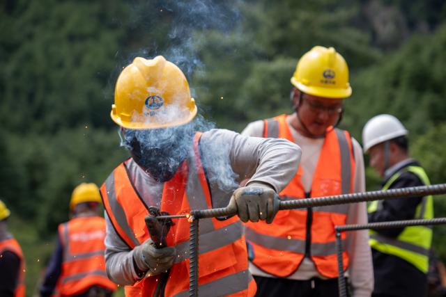 (260830) -- GYIRONG, Aug. 30, 2026 (Xinhua) -- Workers from China Railway Group Limited weld steel-reinforced gabion baskets at a temporary processing site in Gyirong County, southwest China's Xizang Autonomous Region, Aug. 30, 2026. Workers from China Railway Group Limited stepped up efforts on Sunday to make steel-reinforced gabion baskets to support the restoration of road access to mudslide-hit areas in Gyirong County for rescue operations. (Xinhua/Tenzing Nima Qadhup)