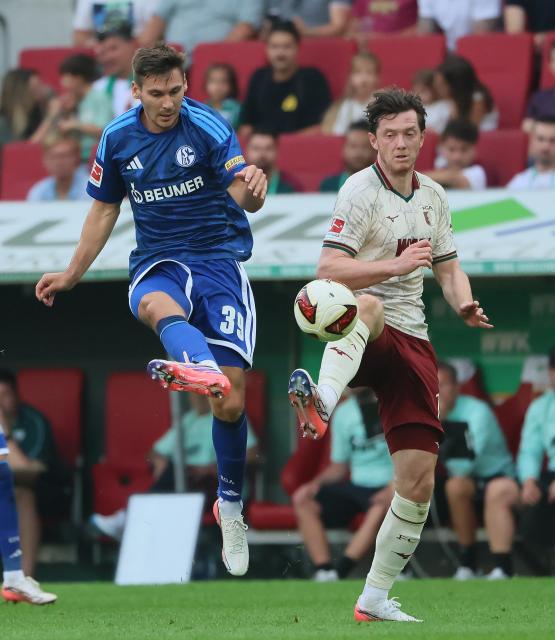 (260831) -- AUGSBURG, Aug. 31, 2026 (Xinhua) -- Michael Gregoritsch (R) of FC Augsburg vies with Maximilian Woeber of FC Schalke 04 during the German first division Bundesliga football match between FC Augsburg and FC Schalke 04 in Augsburg, Germany, Aug. 30, 2026. (Photo by Philippe Ruiz/Xinhua)