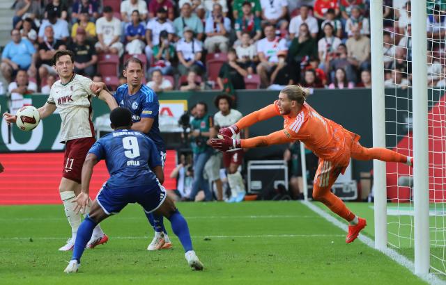 (260831) -- AUGSBURG, Aug. 31, 2026 (Xinhua) -- Goalkeeper of FC Schalke 04 Loris Karius (1st R) makes a save during the German first division Bundesliga football match between FC Augsburg and FC Schalke 04 in Augsburg, Germany, Aug. 30, 2026. (Photo by Philippe Ruiz/Xinhua)