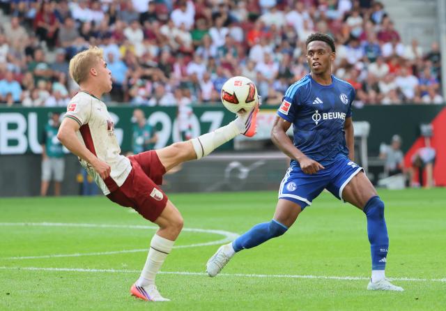 (260831) -- AUGSBURG, Aug. 31, 2026 (Xinhua) -- Hennes Behrens (L) of FC Augsburg vies with Junior Adamu of FC Schalke 04 during the German first division Bundesliga football match between FC Augsburg and FC Schalke 04 in Augsburg, Germany, Aug. 30, 2026. (Photo by Philippe Ruiz/Xinhua)