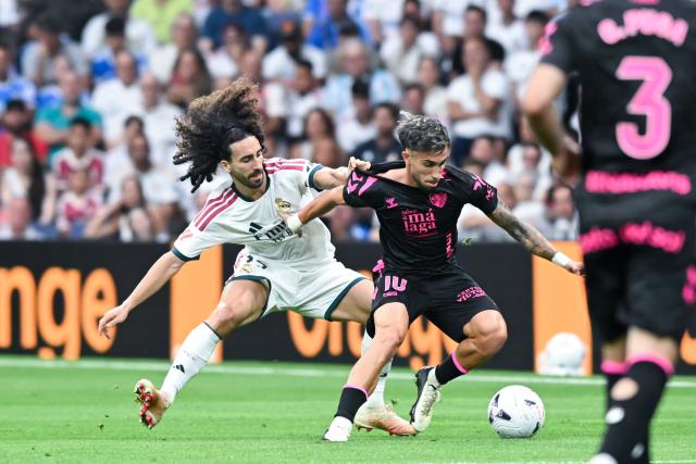 (260831) -- MADRID, Aug. 31, 2026 (Xinhua) -- Real Madrid's Marc Cucurella (L) vies with Malaga's David Larrubia during a La Liga football match between Real Madrid and Malaga CF at Santiago Bernabeu stadium in Madrid, Spain, on Aug. 30, 2026. (Photo by Gustavo Valiente/Xinhua)