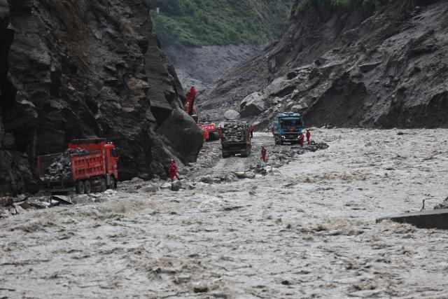 (260831) -- GYIRONG, Aug. 31, 2026 (Xinhua) -- Rescuers repair a section of national highway G216 in Gyirong County, southwest China's Xizang Autonomous Region, on Aug. 31, 2026.
  Rescuers with China Anneng are carrying out clearing and restoration operations on the damaged road sections, striving to restore the vital access route to Gyirong Port. (Xinhua/Jiang Fan)