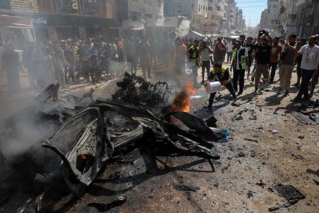 (260831) -- GAZA, Aug. 31, 2026 (Xinhua) -- A Palestinian extinguishes fire in a destroyed vehicle following an Israeli drone strike in the Tel al-Hawa neighborhood in Gaza City, Aug. 31, 2026. Three Palestinians were killed on Monday in an Israeli strike targeting a vehicle in Gaza City, according to Palestinian medical sources. (Photo by Rizek Abdeljawad/Xinhua)