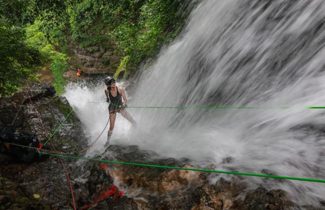 (260901) -- BEIJING, Sept. 1, 2026 (Xinhua) -- A woman experiences waterfall rappelling in Yangshuo County of Guilin City, south China's Guangxi Zhuang Autonomous Region, Aug. 30, 2026. (Photo by Liu Jiaoqing/Xinhua)