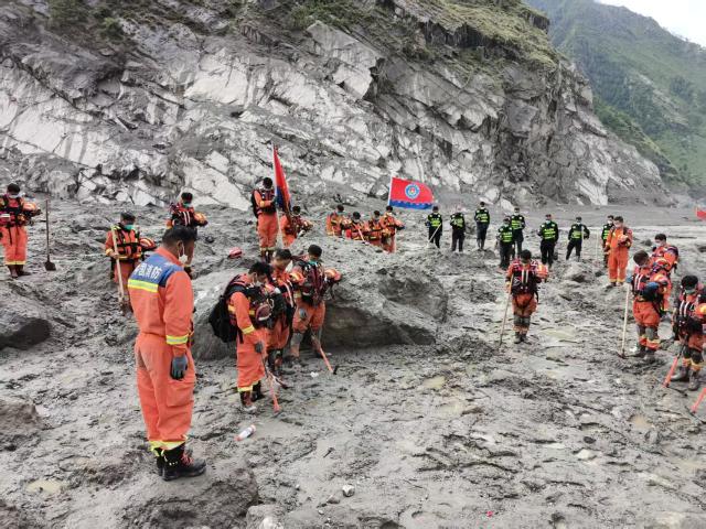 (260901) -- GYIRONG, Sept. 1, 2026 (Xinhua) -- Rescuers observe a moment of silence for the victims of the Aug. 26 mudslide near the Gyirong Port in Gyirong County, southwest China's Xizang Autonomous Region, Sept. 1, 2026. Memorial services were held on Tuesday morning in Gyirong County, southwest China's Xizang Autonomous Region, to mourn the victims of the Aug. 26 mudslide that caused heavy casualties and left many missing. (Xinhua/Jigme Dorje)