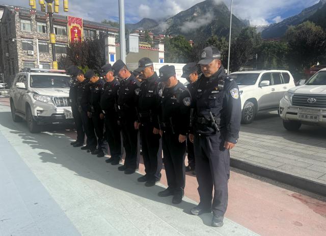 (260901) -- GYIRONG, Sept. 1, 2026 (Xinhua) -- Policemen observe a moment of silence for the victims of the Aug. 26 mudslide in Gyirong County, southwest China's Xizang Autonomous Region, Sept. 1, 2026. Memorial services were held on Tuesday morning in Gyirong County, southwest China's Xizang Autonomous Region, to mourn the victims of the Aug. 26 mudslide that caused heavy casualties and left many missing. (Xinhua/Tenzing Nima Qadhup)