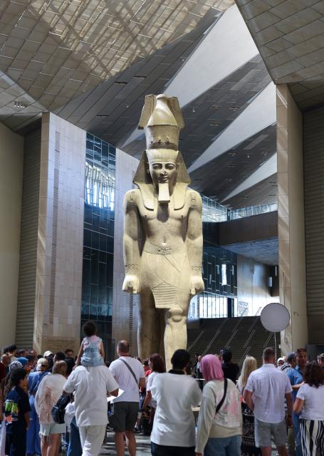 (260901) -- CAIRO, Sept. 1, 2026 (Xinhua) -- Tourists stand around the colossus of ancient Egyptian pharaoh Ramses II at the Grand Egyptian Museum in Giza, Egypt, Aug. 27, 2026. Egypt is home to an ancient civilization that flourished along the Nile River. From the pyramids that have stood for millennia to its bustling modern cities, the ancient and the contemporary intertwine across the country, reflecting a civilization that has endured through the ages. (Xinhua/Yao Dawei)
