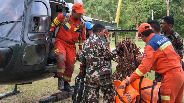 (260903) -- KATHMANDU, Sept. 3, 2026 (Xinhua) -- This screenshot from a video clip taken on Aug. 31, 2026 shows Chinese tunnel rescue experts and Nepalese rescuers returning from a search mission at a rescue command center in Nuwakot District, Nepal.
  TO GO WITH "Feature: Braving chest-deep mud, Chinese rescue team races to find survivors in mudslide-hit Nepal" (Xinhua/Zhao Manjun)