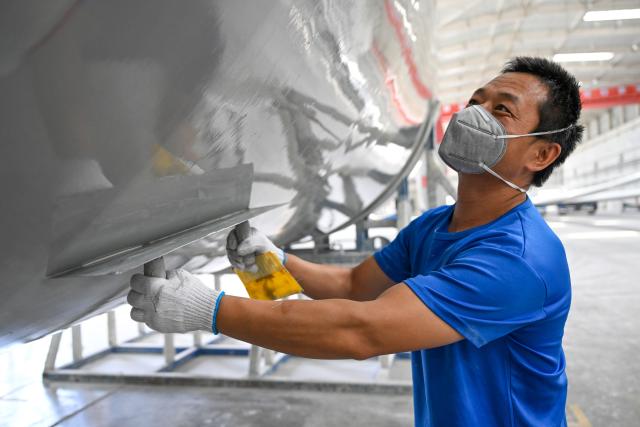 (260903) -- URUMQI, Sept. 3, 2026 (Xinhua) -- A staff member is busy at a processing workshop of wind turbine blades in a new materials company in Changji City, northwest China's Xinjiang Uygur Autonomous Region, Aug. 31, 2026.
  By leveraging its rich resources, Xinjiang has made remarkable progress in developing the new materials sector and forging new growth engines in recent years. Years of sustained effort to achieve breakthroughs in core technologies in key fields and in smart manufacturing of new materials have boosted industrial cluster formation and drive high-quality growth in the region. (Xinhua/Ding Lei)