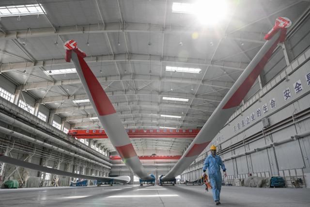 (260903) -- URUMQI, Sept. 3, 2026 (Xinhua) -- A staff member is busy at a processing workshop of wind turbine blades in a new materials company in Changji City, northwest China's Xinjiang Uygur Autonomous Region, Aug. 31, 2026.
  By leveraging its rich resources, Xinjiang has made remarkable progress in developing the new materials sector and forging new growth engines in recent years. Years of sustained effort to achieve breakthroughs in core technologies in key fields and in smart manufacturing of new materials have boosted industrial cluster formation and drive high-quality growth in the region. (Xinhua/Ding Lei)