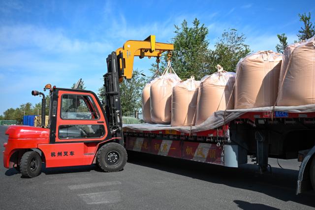 (260903) -- URUMQI, Sept. 3, 2026 (Xinhua) -- A staff member loads sacks of chemical materials onto a vehicle at a new chemical materials company in Changji City, northwest China's Xinjiang Uygur Autonomous Region, Aug. 31, 2026.
  By leveraging its rich resources, Xinjiang has made remarkable progress in developing the new materials sector and forging new growth engines in recent years. Years of sustained effort to achieve breakthroughs in core technologies in key fields and in smart manufacturing of new materials have boosted industrial cluster formation and drive high-quality growth in the region. (Xinhua/Ding Lei)