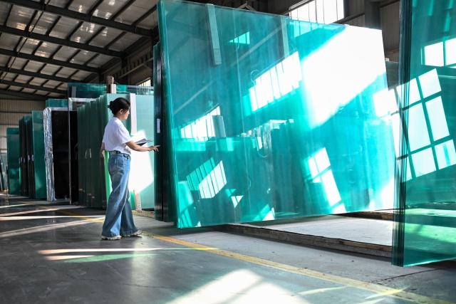 (260903) -- URUMQI, Sept. 3, 2026 (Xinhua) -- A staff member checks inventory at the warehouse of a special glass company in Yining City, northwest China's Xinjiang Uygur Autonomous Region, Sept. 2, 2026.
  By leveraging its rich resources, Xinjiang has made remarkable progress in developing the new materials sector and forging new growth engines in recent years. Years of sustained effort to achieve breakthroughs in core technologies in key fields and in smart manufacturing of new materials have boosted industrial cluster formation and drive high-quality growth in the region. (Xinhua/Ding Lei)