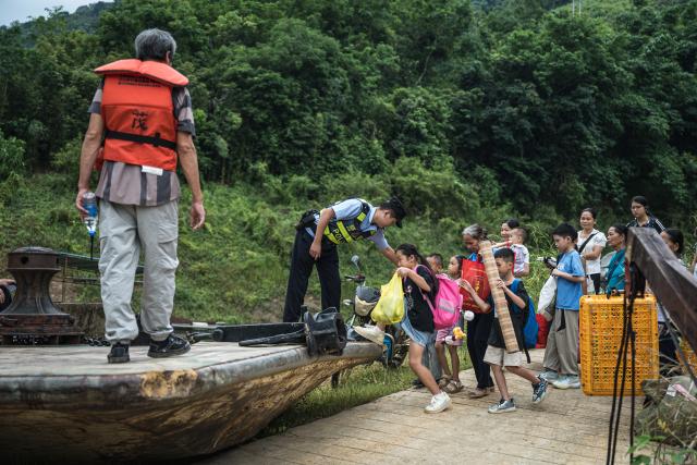 (260903) -- KUNMING, Sept. 3, 2026 (Xinhua) -- Students and their guardians board a ferry in Bo'ai Town of Funing County, Wenshan Zhuang and Miao Autonomous Prefecture, southwest China's Yunnan Province, Aug. 30, 2026. (Xinhua/Wang Guansen)