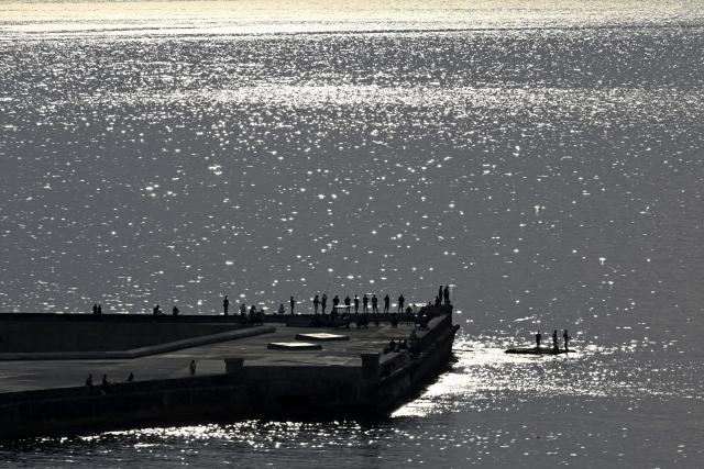 (260903) -- HAVANA, Sept. 3, 2026 (Xinhua) -- People fish by the seaside in Havana, capital of Cuba, Aug. 30, 2026. (Xinhua/Li Muzi)