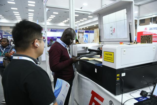(260903) -- NAIROBI, Sept. 3, 2026 (Xinhua) -- A visitor looks at a laser-engraving machine exhibited by a Chinese enterprise at the 9th Kenya International Industrial Expo in Nairobi, Kenya, Sept. 3, 2026. TO GO WITH "Kenya looks to China to boost industrial upgrade" (Xinhua/Liu Qiong)