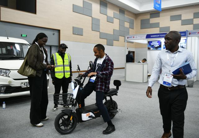 (260903) -- NAIROBI, Sept. 3, 2026 (Xinhua) -- A visitor tries an electric bike exhibited by a Chinese enterprise at the 9th Kenya International Industrial Expo in Nairobi, Kenya, Sept. 3, 2026. TO GO WITH "Kenya looks to China to boost industrial upgrade" (Xinhua/Liu Qiong)