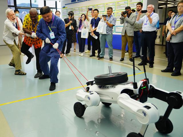 (260904) -- BEIJING, Sept. 4, 2026 (Xinhua) -- Guests have a tug-of-war competition with an intelligent inspection robot dog at Hengqin Digital Zero-Carbon Island Shared Laboratory of China Southern Power Grid (CSG) in Zhuhai, south China's Guangdong Province, Sept. 3, 2026. The Asia-Pacific Media Forum will open on Saturday in Shenzhen, south China's Guangdong Province, as the country hosts a series of events during the 2026 APEC "China Year."
   Ahead of the event, participating guests are visiting cities in Guangdong, including Guangzhou, Foshan, Dongguan, Shenzhen, Zhuhai and Zhongshan. (Xinhua/Li An)