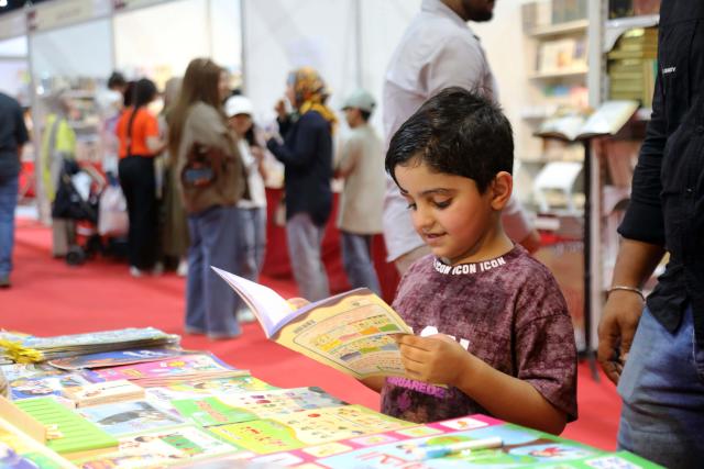 (260904) -- BEIJING, Sept. 4, 2026 (Xinhua) -- A boy reads a book at the 27th Baghdad International Book Fair in Baghdad, Iraq, on Sept. 2, 2026. The 27th Baghdad International Book Fair runs here from Sept. 2 to 12. (Xinhua/Khalil Dawood)