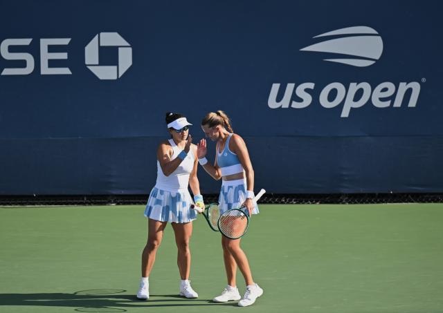 (260904) -- NEW YORK, Sept. 4, 2026 (Xinhua) -- Guo Hanyu(L)/Kristina Mladenovic celebrate scoring during the women's doubles first round match between Guo Hanyu(China)/Kristina Mladenovic(France) and Maja Chwalinska/Madga Linette of Poland at the 2026 US Open tennis championships in New York, the United States, Sept. 3, 2026. (Xinhua/Li Rui)