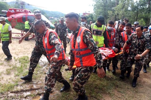 (260904) -- KATHMANDU, Sept. 4, 2026 (Xinhua) -- Rescuers transfer a worker rescued alive in Rasuwa district, Nepal, Sept. 4, 2026. Two men trapped inside the tunnel of the Trishuli 3A hydropower project, which was badly affected by last week's deadly mudslide, were rescued alive on Friday, the Nepali Army said. (RSS via Xinhua)