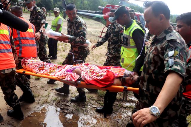 (260904) -- KATHMANDU, Sept. 4, 2026 (Xinhua) -- Rescuers transfer a worker rescued alive in Rasuwa district, Nepal, Sept. 4, 2026. Two men trapped inside the tunnel of the Trishuli 3A hydropower project, which was badly affected by last week's deadly mudslide, were rescued alive on Friday, the Nepali Army said. (RSS via Xinhua)