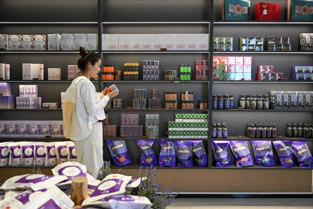 (260904) -- YINING, Sept. 4, 2026 (Xinhua) -- A visitor selects lavender products at an exhibition hall in Yining, northwest China's Xinjiang Uygur Autonomous Region, Sept. 2, 2026. In recent years, advances in agricultural technology have become key helpers for Xinjiang's farmers. Mechanization and intelligent facilities are now widely used from planting to harvesting. (Xinhua/Ding Lei)