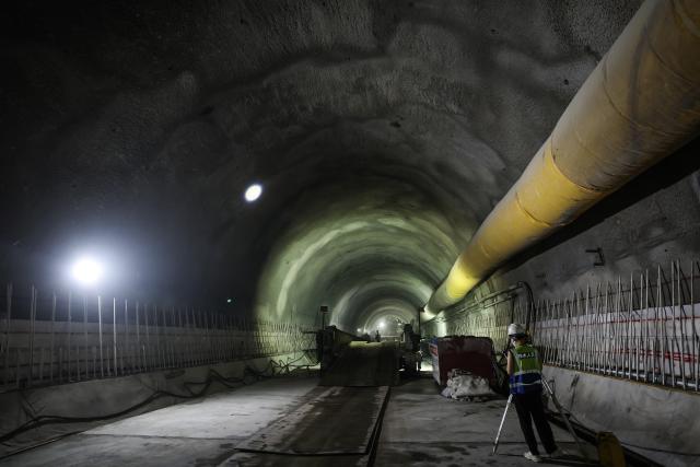 (260904) -- NINGBO, Sept. 4, 2026 (Xinhua) -- Construction workers inspect the condition of the entrance of the Jintang undersea tunnel, east China's Zhejiang Province, Sept. 4, 2026. The 7.83-km land section of the 16.18-km Jintang undersea tunnel achieved full breakthrough on Friday. The tunnel is an important facility for the Yongzhou (Ningbo-Zhoushan) high-speed railway, and is designed as a single-bore, double-track tunnel for speeds of up to 250 km per hour. (Xinhua/Xu Yu)