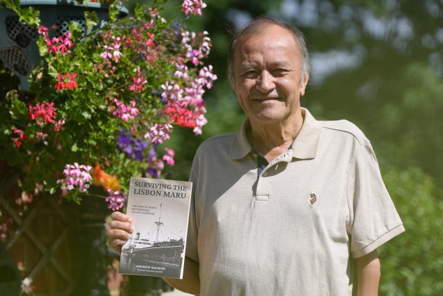 (260905) -- LONDON, Sept. 5, 2026 (Xinhua) -- This photo taken on Aug. 28, 2026 shows Kenneth Salmon holding the book "Surviving the Lisbon Maru" in Fleet, Britain. TO GO WITH "Interview: Father's wartime diary demonstrates best, worst of human nature: Lisbon Maru survivor's son" (Xinhua/Zhang Feng)