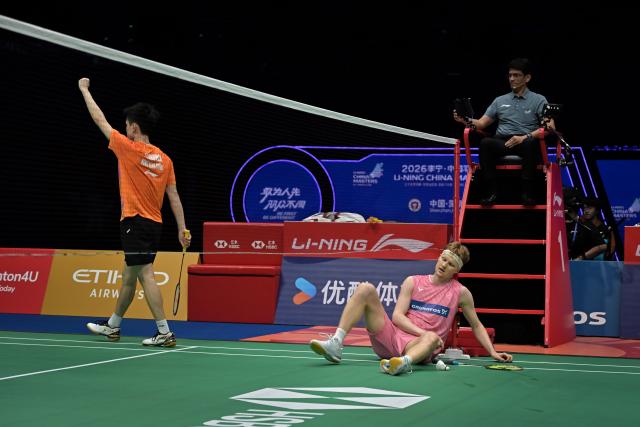 (260905) -- SHENZHEN, Sept. 5, 2026 (Xinhua) -- Jason Gunawan (L) reacts after the men's singles semifinal match between Jason Gunawan of China's Hong Kong and Anders Antonsen of Denmark at China Masters 2026 badminton tournament in Shenzhen, south China's Guangdong Province, Sept. 5, 2026. (Photo by Chu Yan/Xinhua)