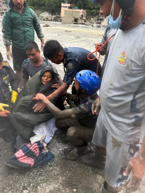 (260905) -- KATHMANDU, Sept. 5, 2026 (Xinhua) -- A woman is rescued alive in Nuwako district, Nepal, Sept. 5, 2026. A 64-year-old Nepali woman was rescued alive Saturday in Nuwako district 10 days after the deadly mudslide on Aug. 26, local media reported. (Nepal Armed Police Force/Handout via Xinhua)