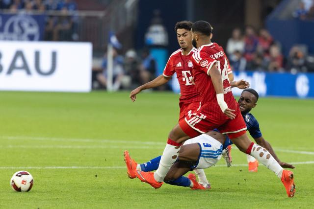 (260906) -- GELSENKIRCHEN, Sept. 6, 2026 (Xinhua) -- Moussa Sylla (bottom) of FC Schalke 04 vies with Nathaniel Brown (rear) and Ismael Saibari of FC Bayern Munich during the German first division Bundesliga football match between FC Schalke 04 and FC Bayern Munich in Gelsenkirchen, Germany, Sept. 5, 2026. (Photo by Joachim Bywaletz/Xinhua)