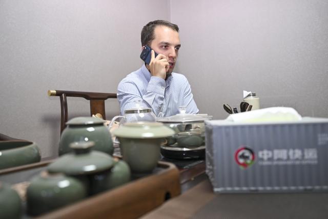 (260906) -- URUMQI, Sept. 6, 2026 (Xinhua) -- Arseniy Kretov works at an office in Urumqi, northwest China's Xinjiang Uygur Autonomous Region, Sept. 2, 2026.
  Arseniy Kretov, 27, who goes by the Chinese name Yu Hao, hails from Tashkent, Uzbekistan. He is the regional representative of O'ZTEMIRYO'LKONTEYNER (UTK) in China and mainly works in cross-border logistics. 
  Interested in China, Arseniy went to Nanjing in Jiangsu Province to study. During his three years there, he was deeply impressed by China's transportation, medical services and food. After starting his career, UTK dispatched Arseniy to Xinjiang because he was fluent in Chinese. 
  Arseniy currently works with a Chinese team in Urumqi. His company transports consumer goods, electronic products, fabrics and other products made in China to countries in Central Asia and elsewhere. 
  Although Arseniy has worked in Xinjiang for less than a year, he has already found many market opportunities. His team's business volume has increased every month, which has given him more confidence. Arseniy said logistics between China and Central Asia is more than just a job for him. It is a field with promising prospects. (Xinhua/Hu Huhu)