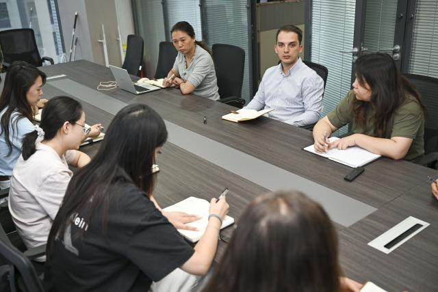 (260906) -- URUMQI, Sept. 6, 2026 (Xinhua) -- Arseniy Kretov (2nd R, back) attends a meeting with team members at an office in Urumqi, northwest China's Xinjiang Uygur Autonomous Region, Sept. 2, 2026.
  Arseniy Kretov, 27, who goes by the Chinese name Yu Hao, hails from Tashkent, Uzbekistan. He is the regional representative of O'ZTEMIRYO'LKONTEYNER (UTK) in China and mainly works in cross-border logistics. 
  Interested in China, Arseniy went to Nanjing in Jiangsu Province to study. During his three years there, he was deeply impressed by China's transportation, medical services and food. After starting his career, UTK dispatched Arseniy to Xinjiang because he was fluent in Chinese. 
  Arseniy currently works with a Chinese team in Urumqi. His company transports consumer goods, electronic products, fabrics and other products made in China to countries in Central Asia and elsewhere. 
  Although Arseniy has worked in Xinjiang for less than a year, he has already found many market opportunities. His team's business volume has increased every month, which has given him more confidence. Arseniy said logistics between China and Central Asia is more than just a job for him. It is a field with promising prospects. (Xinhua/Hu Huhu)
