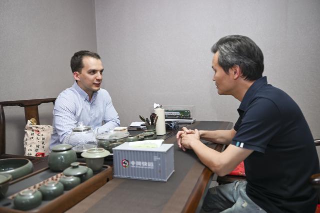 (260906) -- URUMQI, Sept. 6, 2026 (Xinhua) -- Arseniy Kretov talks with his client at an office in Urumqi, northwest China's Xinjiang Uygur Autonomous Region, Sept. 2, 2026.
  Arseniy Kretov, 27, who goes by the Chinese name Yu Hao, hails from Tashkent, Uzbekistan. He is the regional representative of O'ZTEMIRYO'LKONTEYNER (UTK) in China and mainly works in cross-border logistics. 
  Interested in China, Arseniy went to Nanjing in Jiangsu Province to study. During his three years there, he was deeply impressed by China's transportation, medical services and food. After starting his career, UTK dispatched Arseniy to Xinjiang because he was fluent in Chinese. 
  Arseniy currently works with a Chinese team in Urumqi. His company transports consumer goods, electronic products, fabrics and other products made in China to countries in Central Asia and elsewhere. 
  Although Arseniy has worked in Xinjiang for less than a year, he has already found many market opportunities. His team's business volume has increased every month, which has given him more confidence. Arseniy said logistics between China and Central Asia is more than just a job for him. It is a field with promising prospects. (Xinhua/Hu Huhu)