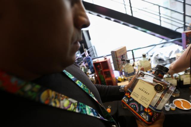 (260906) -- MEXICO CITY, Sept. 6, 2026 (Xinhua) -- A man looks at the label on a bottle of mezcal, an alcoholic beverage made from the agave plant, during the Pulque, Traditional Cuisine and Mezcal Festival in Mexico City, capital of Mexico, Sept. 5, 2026. The event, featuring more than 100 varieties and expressions of agave-based beverages, as well as tastings, food pairings and other activities, was held in Mexico City on Saturday. (Photo by Francisco Canedo/Xinhua)