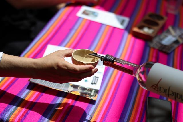 (260906) -- MEXICO CITY, Sept. 6, 2026 (Xinhua) -- A staff member pours mezcal, an alcoholic beverage made from the agave plant, for a visitor during the Pulque, Traditional Cuisine and Mezcal Festival in Mexico City, capital of Mexico, Sept. 5, 2026. The event, featuring more than 100 varieties and expressions of agave-based beverages, as well as tastings, food pairings and other activities, was held in Mexico City on Saturday. (Photo by Francisco Canedo/Xinhua)