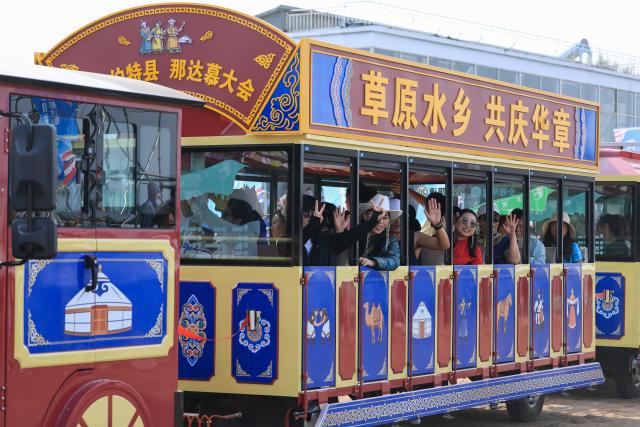 (260906) -- DORBOD, Sept. 6, 2026 (Xinhua) -- Tourists attend the opening ceremony of a Nadam fair in the Mongolian Autonomous County of Dorbod, Daqing City, northeast China's Heilongjiang Province, Sept. 6, 2026. The event was held here on Sunday. It featured cultural performances and folk activities, offering tourists and local residents a celebration of grassland culture. (Photo by Xu Shuai/Xinhua)