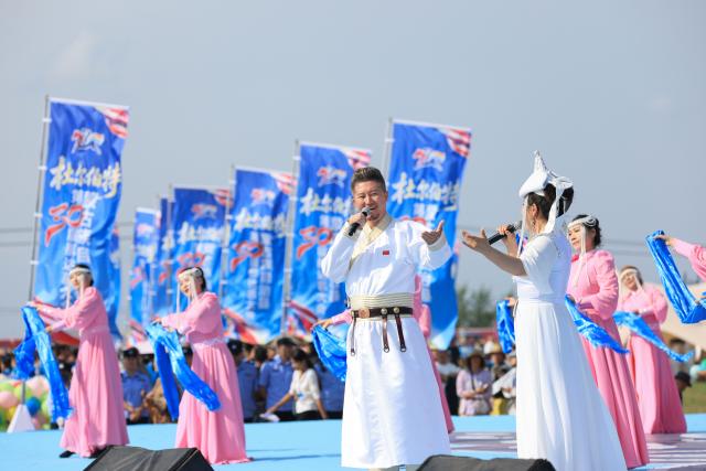 (260906) -- DORBOD, Sept. 6, 2026 (Xinhua) -- Artists perform during the opening ceremony of a Nadam fair in the Mongolian Autonomous County of Dorbod, Daqing City, northeast China's Heilongjiang Province, Sept. 6, 2026. The event was held here on Sunday. It featured cultural performances and folk activities, offering tourists and local residents a celebration of grassland culture. (Photo by Xu Shuai/Xinhua)