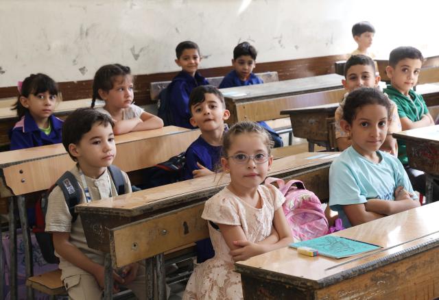 (260906) -- DAMASCUS, Sept. 6, 2026 (Xinhua) -- Students sit in a classroom on the first day of the new school year at a school in Damascus, Syria, Sept. 6, 2026. TO GO WITH "Feature: Syrian families count cost of back-to-school season amid economic strain" (Photo by Ammar Safarjalani/Xinhua)