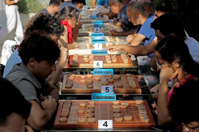 (260907) -- DEIR EL-QAMAR, Sept. 7, 2026 (Xinhua) -- Participants compete in Xiangqi, a traditional Chinese board game also known as the Chinese chess, in the village of Deir el-Qamar, Mount Lebanon, Lebanon, Sept. 6, 2026. An annual championship in Xiangqi was held here on Sunday. (Xinhua/Bilal Jawich)