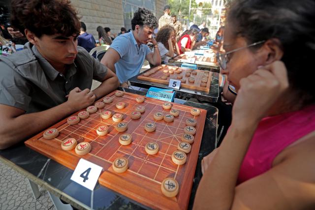 (260907) -- DEIR EL-QAMAR, Sept. 7, 2026 (Xinhua) -- Participants compete in Xiangqi, a traditional Chinese board game also known as the Chinese chess, in the village of Deir el-Qamar, Mount Lebanon, Lebanon, Sept. 6, 2026. An annual championship in Xiangqi was held here on Sunday. (Xinhua/Bilal Jawich)