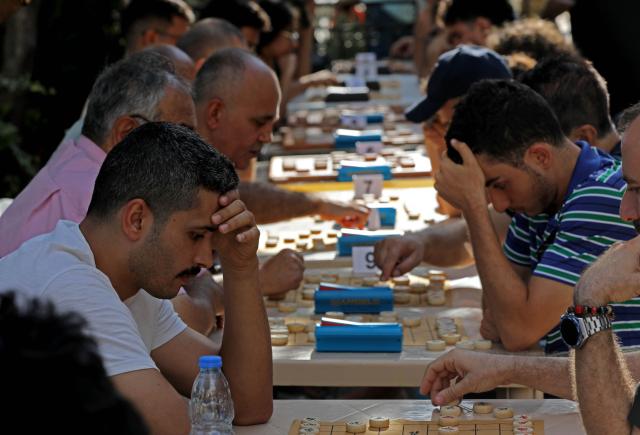 (260907) -- DEIR EL-QAMAR, Sept. 7, 2026 (Xinhua) -- Participants compete in Xiangqi, a traditional Chinese board game also known as the Chinese chess, in the village of Deir el-Qamar, Mount Lebanon, Lebanon, Sept. 6, 2026. An annual championship in Xiangqi was held here on Sunday. (Xinhua/Bilal Jawich)