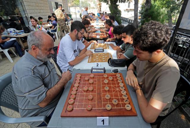 (260907) -- DEIR EL-QAMAR, Sept. 7, 2026 (Xinhua) -- Participants compete in Xiangqi, a traditional Chinese board game also known as the Chinese chess, in the village of Deir el-Qamar, Mount Lebanon, Lebanon, Sept. 6, 2026. An annual championship in Xiangqi was held here on Sunday. (Xinhua/Bilal Jawich)