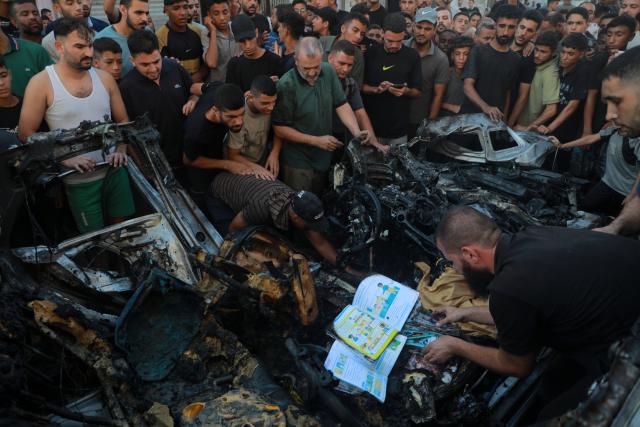 (260907) -- GAZA, Sept. 7, 2026 (Xinhua) -- Palestinians gather around a destroyed vehicle following an Israeli drone strike in the al-Nasr neighborhood, west of Gaza City, on Sept. 6, 2026. Two Palestinians, including a child, were killed and several others injured on Sunday in an Israeli strike targeting a vehicle west of Gaza City, according to medical and local sources. (Photo by Rizek Abdeljawad/Xinhua)