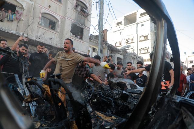 (260907) -- GAZA, Sept. 7, 2026 (Xinhua) -- Palestinians gather around a destroyed vehicle following an Israeli drone strike in the al-Nasr neighborhood, west of Gaza City, on Sept. 6, 2026. Two Palestinians, including a child, were killed and several others injured on Sunday in an Israeli strike targeting a vehicle west of Gaza City, according to medical and local sources. (Photo by Rizek Abdeljawad/Xinhua)