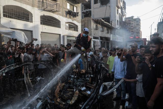 (260907) -- GAZA, Sept. 7, 2026 (Xinhua) -- A Palestinian hoses a destroyed vehicle following an Israeli drone strike in the al-Nasr neighborhood, west of Gaza City, on Sept. 6, 2026. Two Palestinians, including a child, were killed and several others injured on Sunday in an Israeli strike targeting a vehicle west of Gaza City, according to medical and local sources. (Photo by Rizek Abdeljawad/Xinhua)