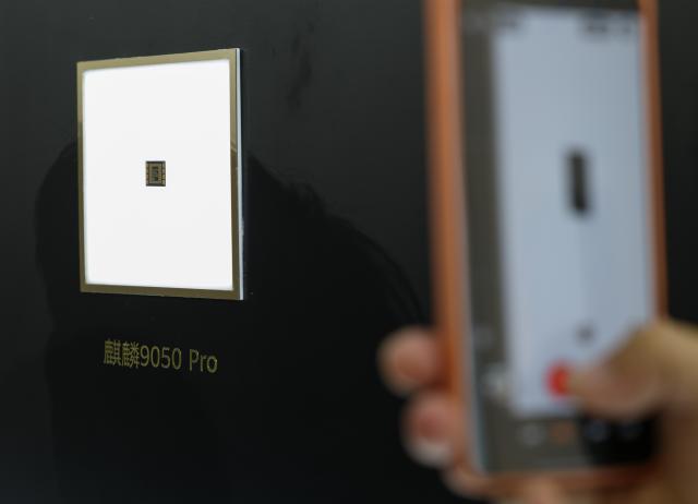 (260907) -- GUANGZHOU, Sept. 7, 2026 (Xinhua) -- An audience member takes photos of Huawei's Kirin 9050 Pro chip on display after a launch event in Guangzhou, south China's Guangdong Province, Sept. 7, 2026. Chinese tech giant Huawei on Monday launched the Mate XT 2 tri-fold smartphone powered by the new Kirin 9050 Pro chip, the first high-performance processor to use logic folding technology.
  The Kirin 9050 Pro stacks logic units in layers within a single chip, shortening signal transmission paths, reducing latency and boosting overall performance, according to a launch event in Guangzhou.
  The last time Huawei introduced a new Kirin chip at a flagship launch was at the global release of the Mate 40 smartphone six years ago. The company has continued to innovate and break new ground in recent years. (Xinhua/Mao Siqian)